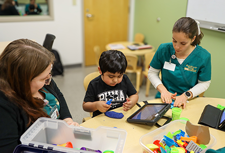 A student in the speech-langauge pathology program works with a patient in USF's Speech-Language Clinic