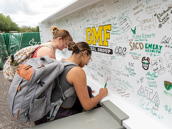 USF students sign beam for the new on-campus stadium