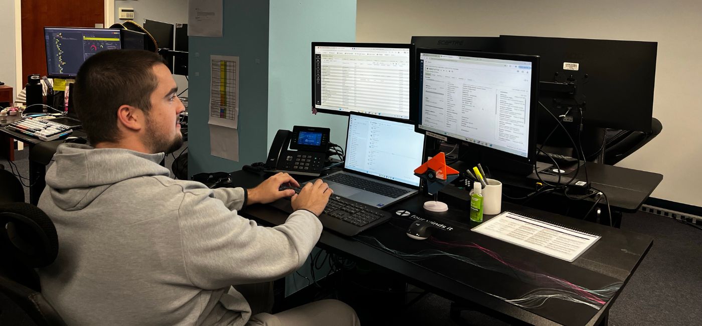 USF student works on a computer as an intern at Four Winds IT
