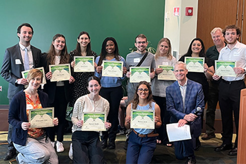 Group of students hold up their certificates