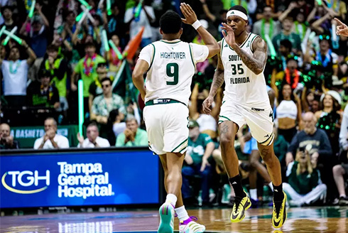 USF basketball players No. 9 and 35 high five