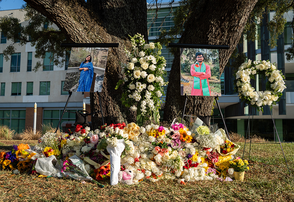 Flowers surround a vigil for two USF students