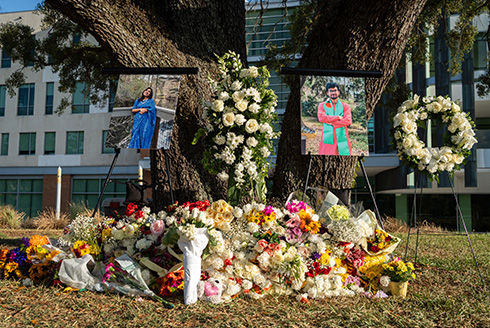 Flowers surround a vigil for two USF student
