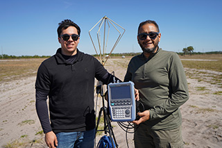 Ryan and colleague hold device