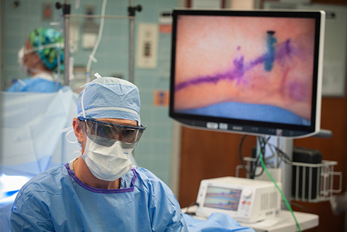 Surgeon uses robotics
