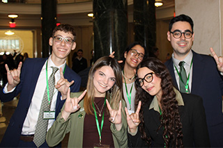 Five students give the Go Bulls hand signal