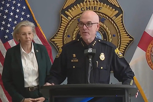 Tampa Police Chief Lee Bercaw stands at a podium near Mayor Jane Castor