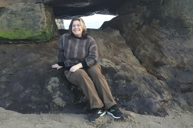 Audrey sitting on rock