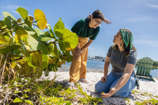 audrey helping a student on the beach