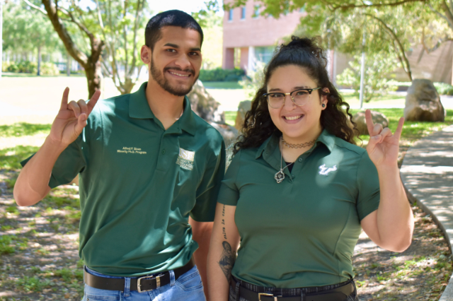 Daniela and Keegan smiling and holding up go bulls hands