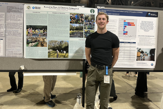 Kobe standing in front of research poster