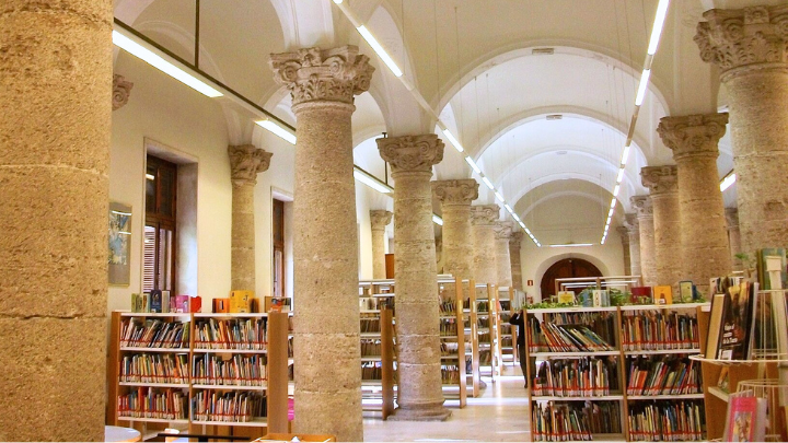 inside of a library with stone columns