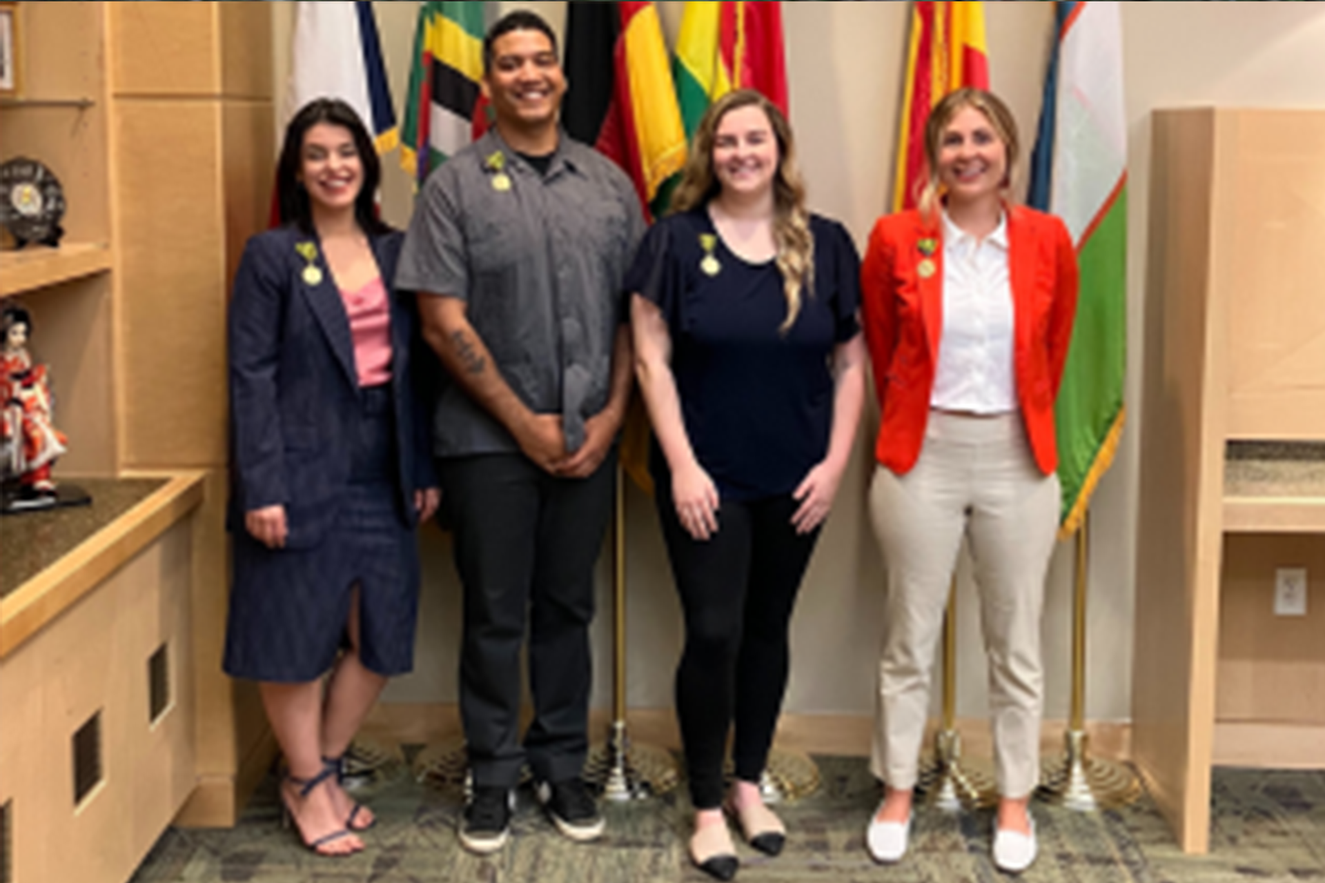 Four Fulbright recipients smile at the camera