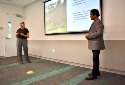 Avani Sanghvi and Dr. Basu present a powerpoint to students in the Finding Your Arc workshop