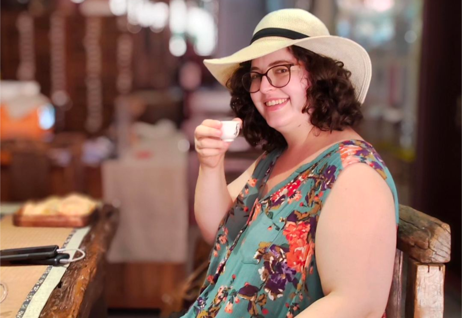 Victoria Brown holds up coffee cup and smiles