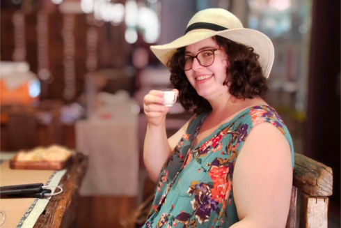 Victoria Brown holds up coffee cup and smiles