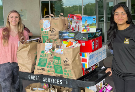 Arni and another executive board member with bags of toys