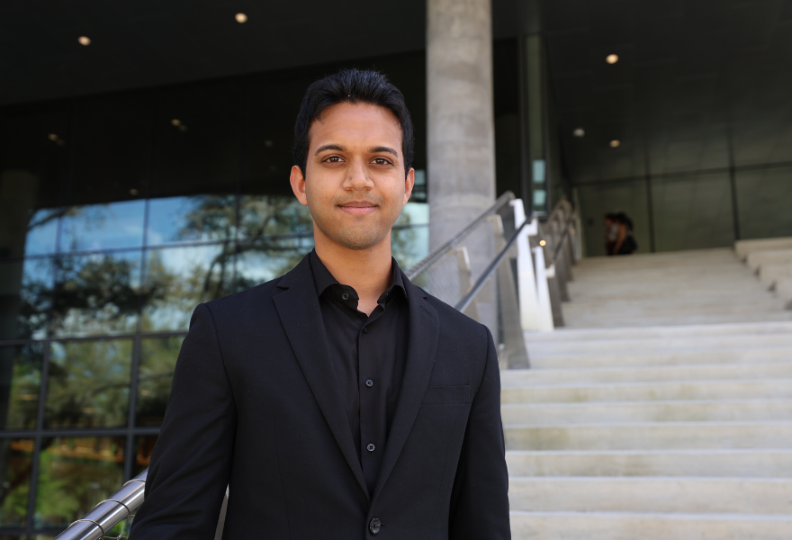 Caleb Fernandes on the steps of the Judy Genshaft Honors College