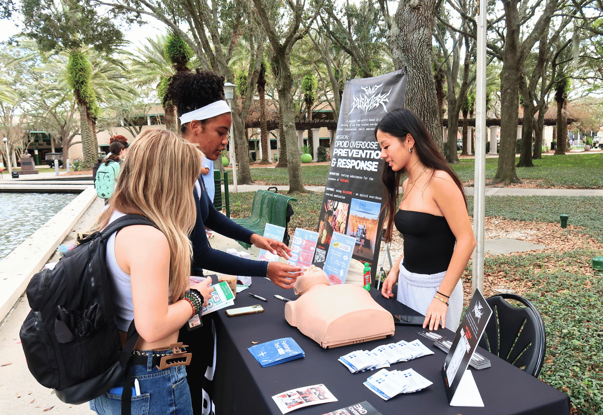 USF students interact at a table for End Overdose outside on USF Tampa campus.