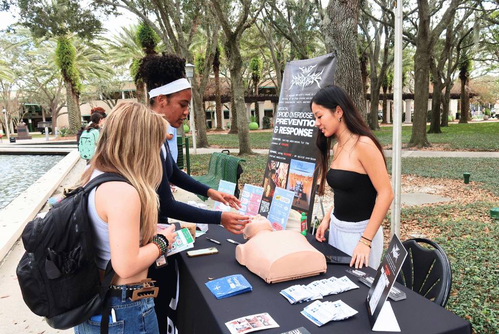USF students interact at a table for End Overdose outside on USF Tampa campus.