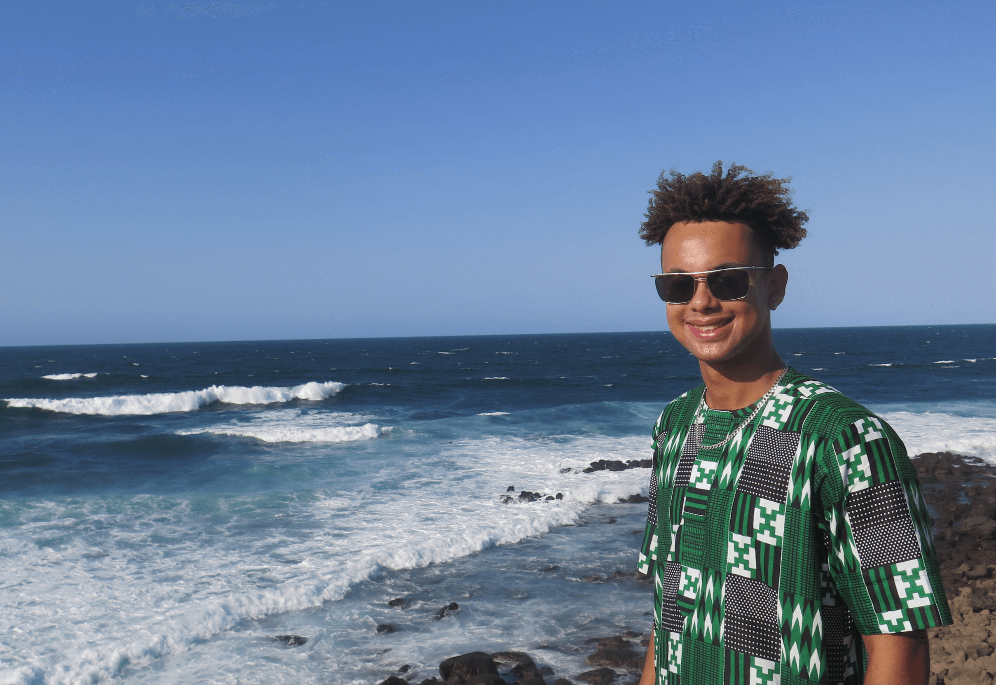 Nico Lavaud poses next to an ocean shore in Senegal.