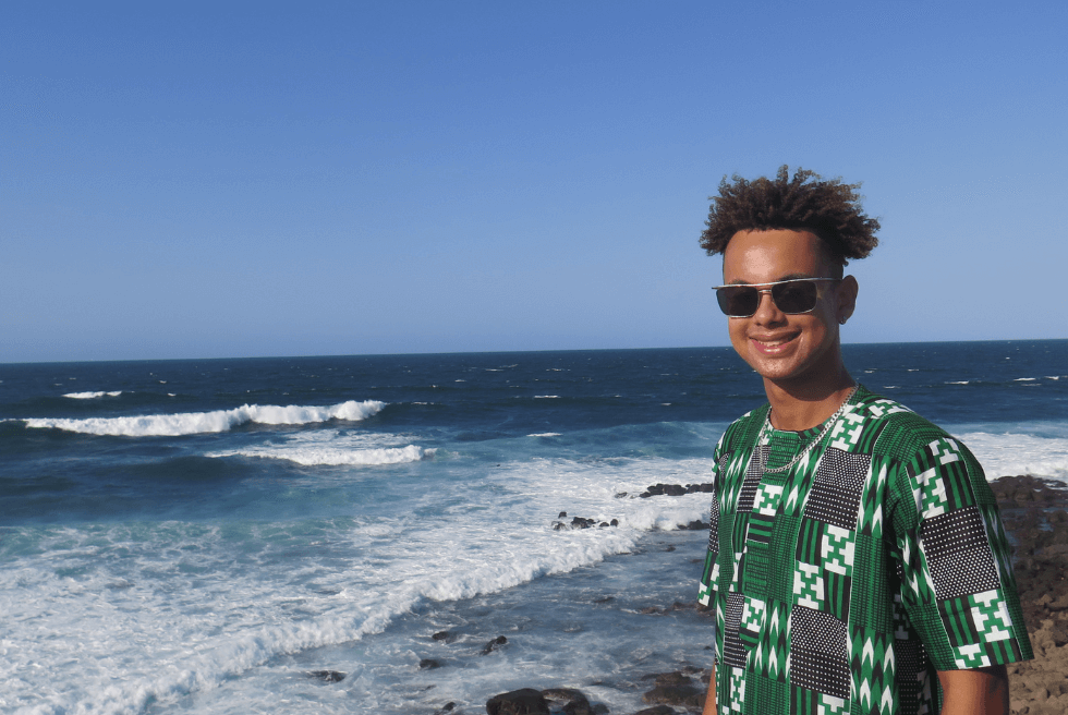 Nico Lavaud poses next to an ocean shore in Senegal.