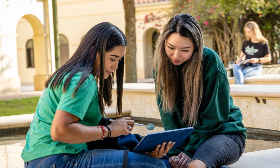 Two women looking at a tablet