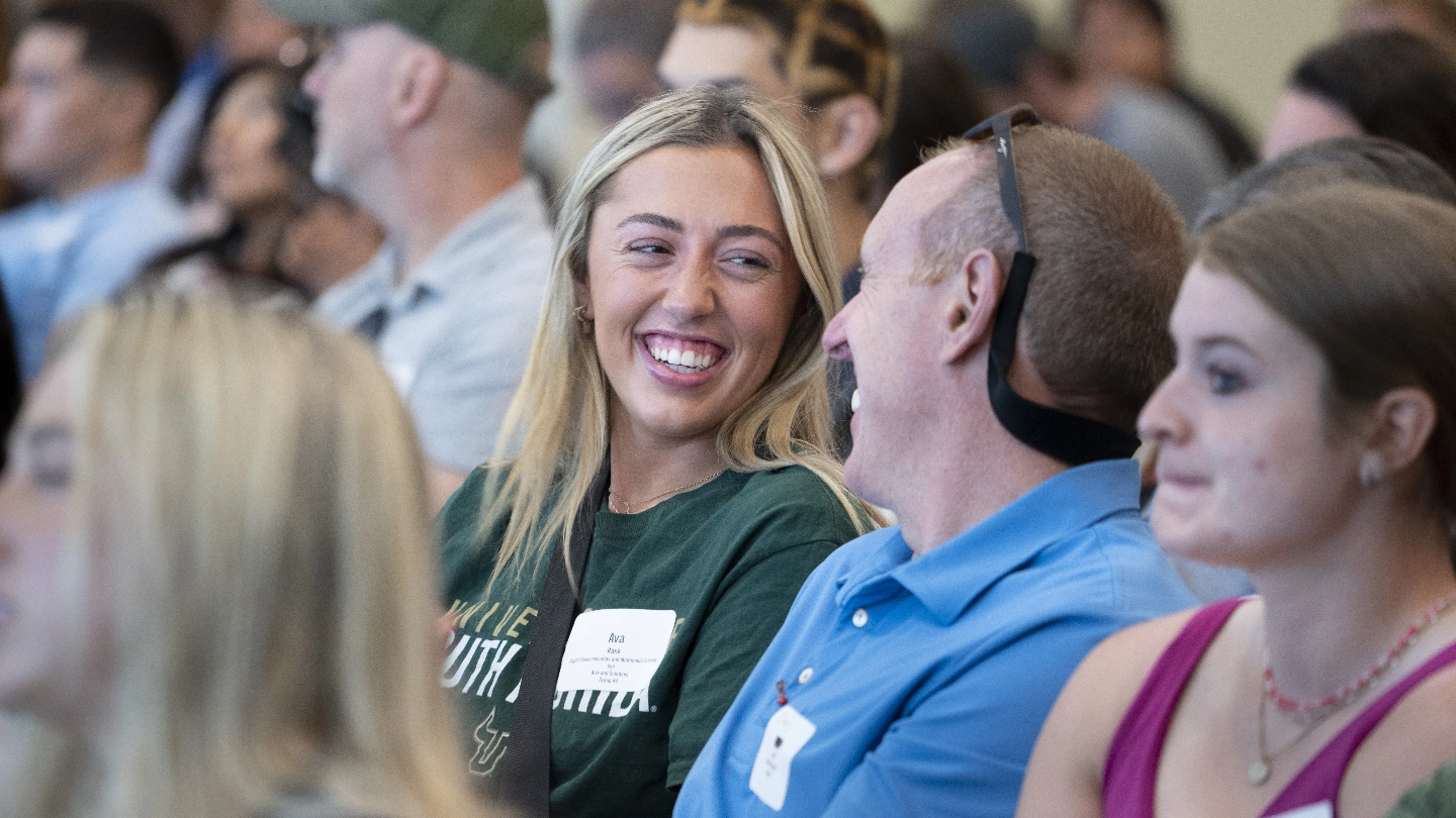 USF student and her father smiling during orientation.