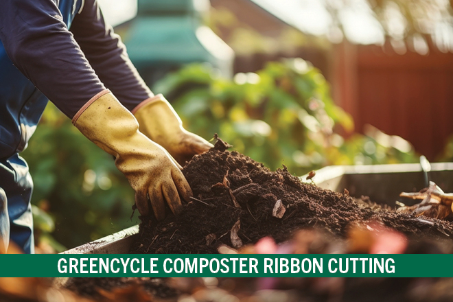 A gardener with yellow gloves putting compost into a bin