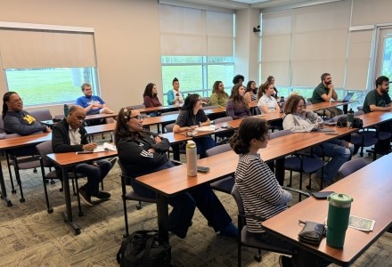 Students and staff watching Cassie's Presentation