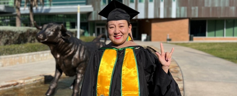 Lujuan outside the Marshall Student Center after Graduating