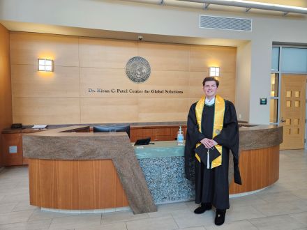 William stands in front of the PCGS welcome desk