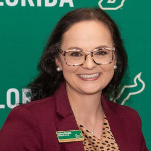 black haired woman smiling at camera