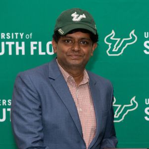 man in usf hat smiling at camera
