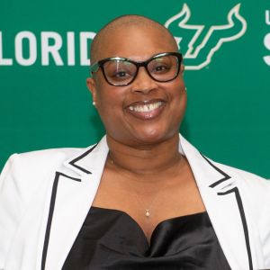 woman with glasses smiling at camera