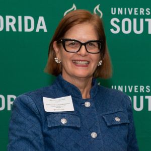 woman in glasses smiling at camera