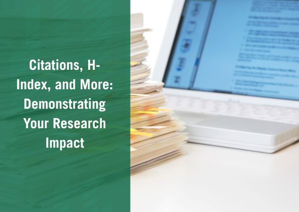 stack of papers in front of computer