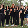 one male and five female student peer educators of the Health Education Action Team posing as a group outside on Tampa campus