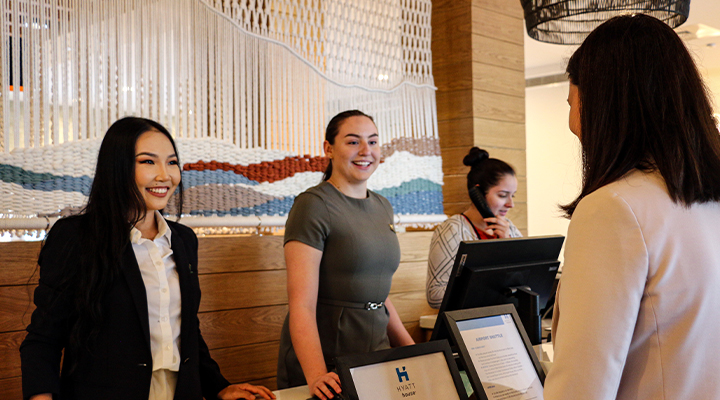 female college intern working registration desk at Hyatt hotel