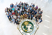 Faculty standing around USF seal