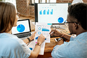 two researchers reviewing charts