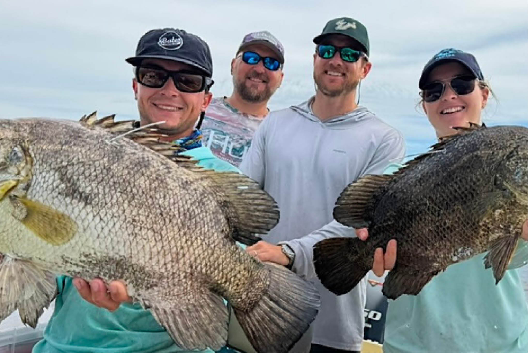 USF team of researchers holding up large fish