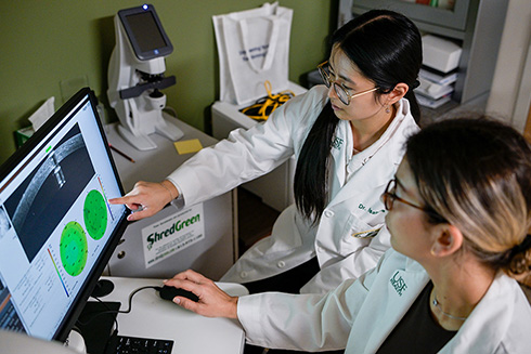 two lab researchers at computer