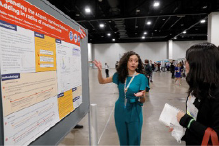 student presenting research poster