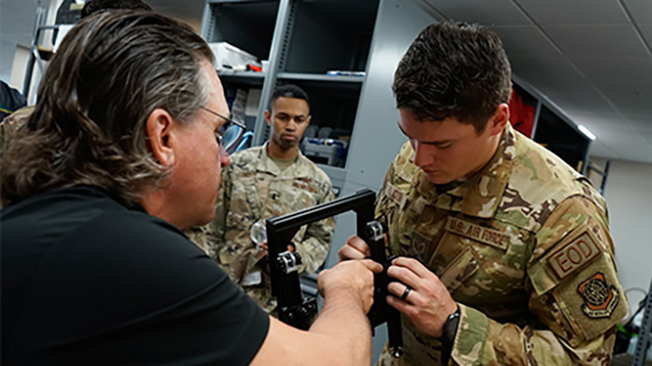 soldiers examining military device