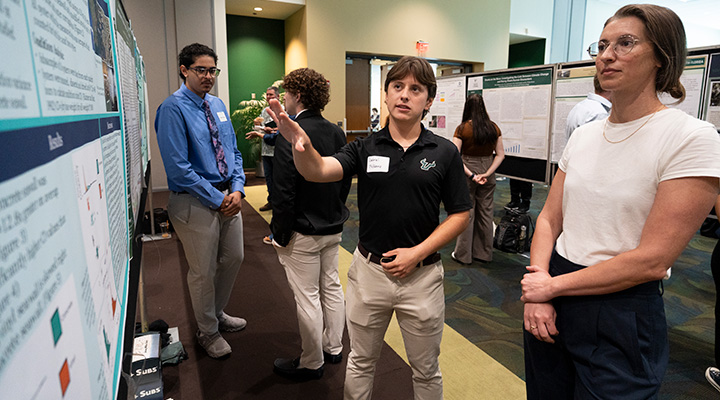 student presents poster at research conference