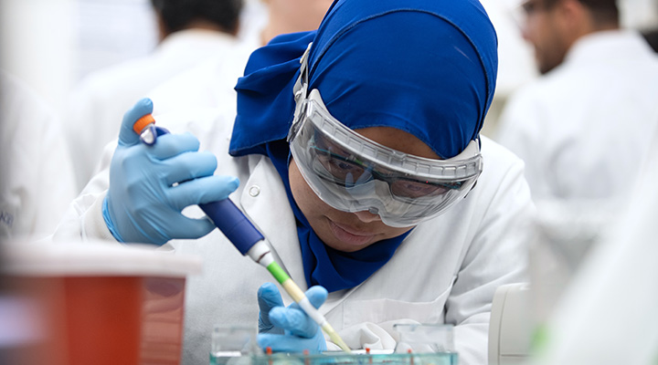student in blue scarf in lab