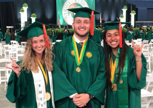 USF students Abby Blocker, Jacob Yarinsky and Carolyna Yamamoto Alves Pinto at their commencement ceremony