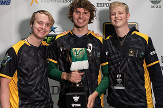 Three USF students attended an esports event and won a trophy.