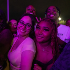 Four students smiling at event